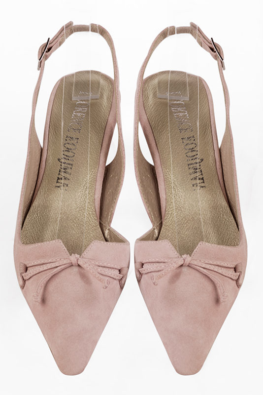 Powder pink open back shoes with a knot. Tapered toe. Medium spool heels